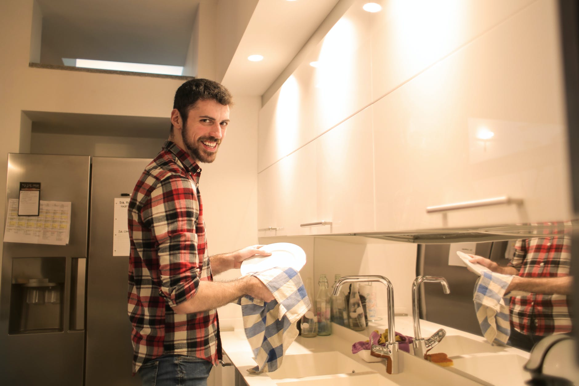 man wiping the dish plates clean